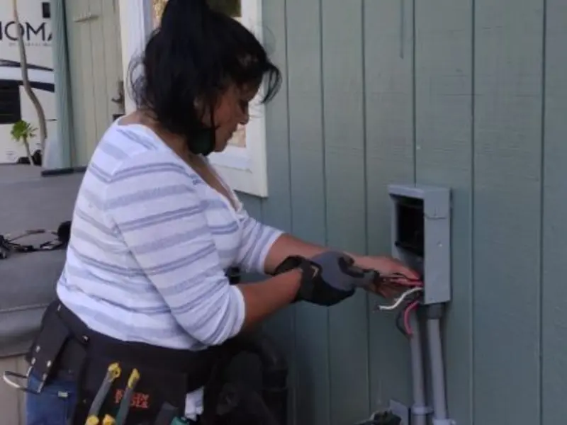Licensed electrician wiring an exterior subpanel in EspaÃÂ±ola